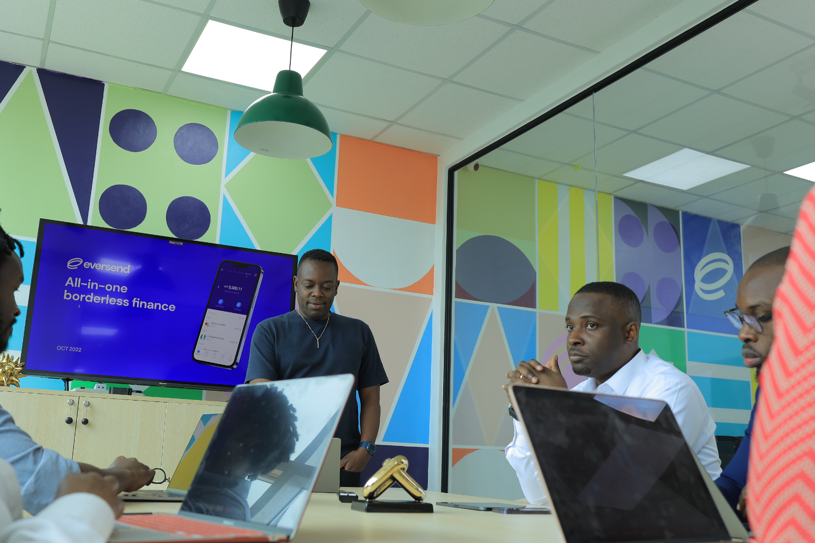 Ronald and Stone presenting Eversend in the Kampala office